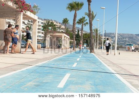 Altea, Spain - September 7, 2016; Tourists enjoying themselves at bar on esplanade cycle-way along waterfront in Altea Spain.