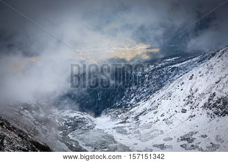 view on foggy valley in winter from Rodna Mountains in Transylvania - Romania