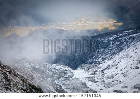 view on foggy valley in winter from Rodna Mountains in Transylvania - Romania