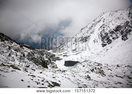 view on foggy valley in winter from Rodna Mountains in Transylvania - Romania