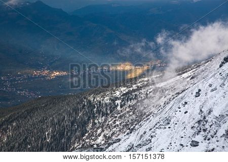 view on foggy valley in winter from Rodna Mountains in Transylvania - Romania