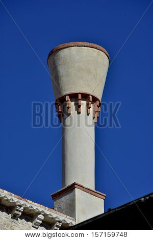 Characteristic venetian truncated cone chimney with blue sky