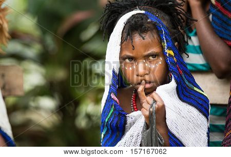 Jiwika, West Papua, Indonesia, February 17th, 2016: dani tribe girl in a village