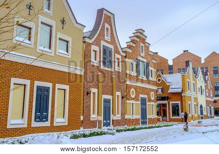 KIEV UKRAINE - NOVEMBER 11 2016: The atmosphere of old Holland in Dutch style shopping neighborhood consisting of brick gambrel-roofed houses with wooden shutters and doors on November 11 in Kiev.