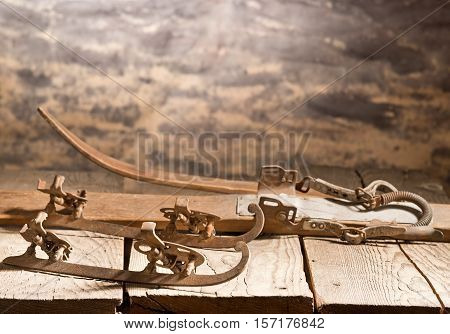 old skies and skates on the wooden table