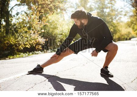 Runner warming up in park. front view