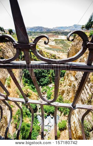 The Puente Nuevo is the newest and largest of three bridges that span the 120-metre (390 ft)-deep chasm that carries the Guadalevín River and divides the city of Ronda in southern Spain.