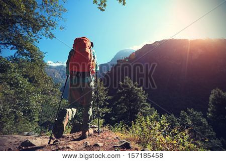 young woman backpacker trekking at the himalaya mountains