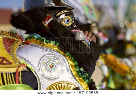 The famous "negritos", dancers dressed in black wool masks dancing at the Festival honoring Virgen del Rosario. October 16, 2012 - Chucuito Province, Puno Region, Peru.