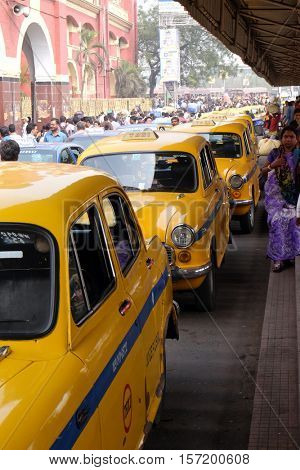 KOLKATA, INDIA - FEBRUARY 10: Yellow Kolkata taxis outside Howrah Railway Station in morning rush hour, Howrah, Kolkata, India on February 10, 2016.