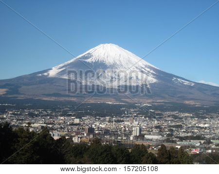 A snow capped Mount Fuji with Gotemba, Shizuoka, Japan below it.