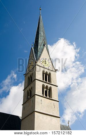 Bell tower with clock of a small church - Santa Maria Val Mustair Village. Grisons Switzerland