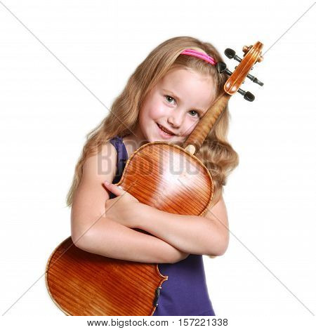 square picture of little girl in purple dress huggs violin against white studio background