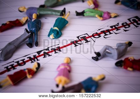 no human rights strikethrough text on paper in retro style with lying people around