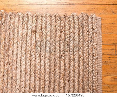 Jute pile hand woven beige area rug on old hardwood floor