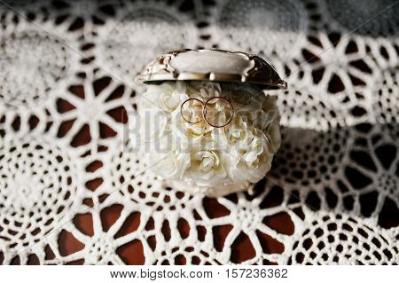 Wedding Rings On Casket Of Jewels With Small Rosses Inside.
