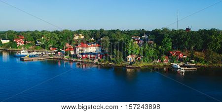 Beautiful super wide-angle aerial view of Stockholm archipelago skerries and suburbs with classic sweden scandinavian designed cottage houses from massive ferryboat