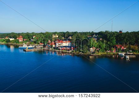 Beautiful super wide-angle aerial view of Stockholm archipelago skerries and suburbs with classic sweden scandinavian designed cottage houses from massive ferryboat