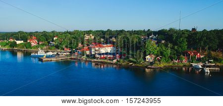 Beautiful super wide-angle aerial view of Stockholm archipelago skerries and suburbs with classic sweden scandinavian designed cottage houses from massive ferryboat