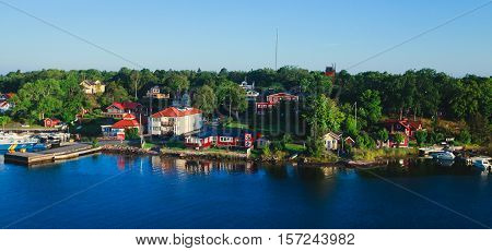 Beautiful super wide-angle aerial view of Stockholm archipelago skerries and suburbs with classic sweden scandinavian designed cottage houses from massive ferryboat