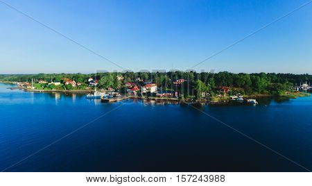 Beautiful super wide-angle aerial view of Stockholm archipelago skerries and suburbs with classic sweden scandinavian designed cottage houses from massive ferryboat