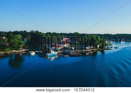 Beautiful super wide-angle aerial view of Stockholm archipelago skerries and suburbs with classic sweden scandinavian designed cottage houses from massive ferryboat