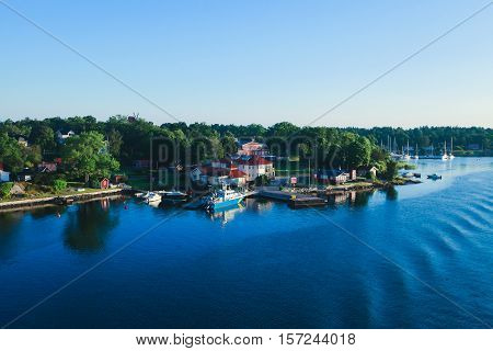 Beautiful super wide-angle aerial view of Stockholm archipelago skerries and suburbs with classic sweden scandinavian designed cottage houses from massive ferryboat