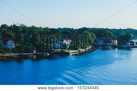 Beautiful super wide-angle aerial view of Stockholm archipelago skerries and suburbs with classic sweden scandinavian designed cottage houses from massive ferryboat