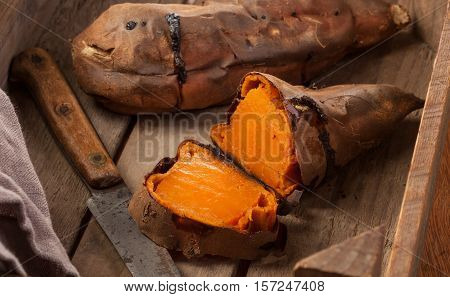 Oven baked sweet potatoes on vintage wood.