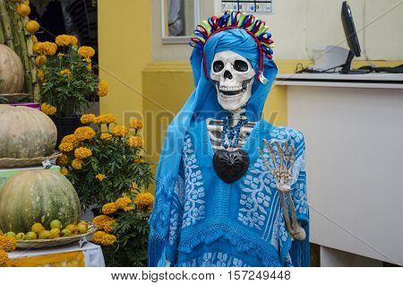 OAXACA, OAXACA, MEXICO - NOVEMBER 1, 2016: Skull dressed with traditional mexican clothes. Part of a mexican day of the dead offering altar