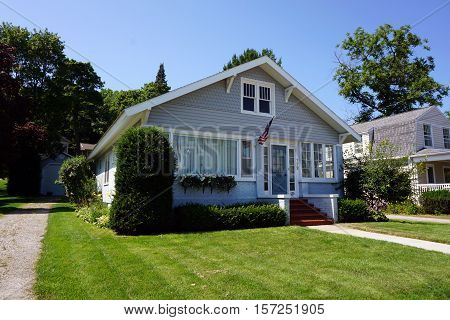 HARBOR SPRINGS, MICHIGAN / UNITED STATES - AUGUST 3, 2016: A brick and stucco home near the Zorn Park Beach in Harbor Springs.