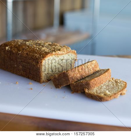 Banana bread with crumble on top sliced on a cutting board