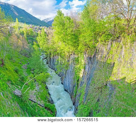 The fast flowing foaming Malkra river in the narrow rocky gorge covered with greenery Mestia Upper Svaneti Georgia.