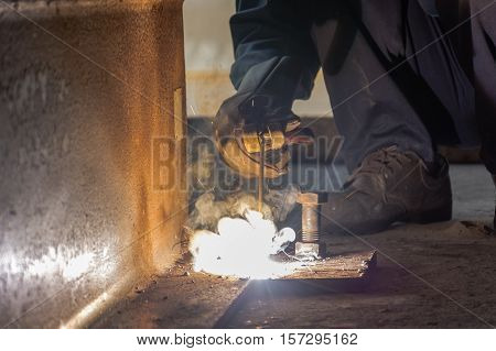 Worker fabricate structure by Shield Metal Arc Welding process