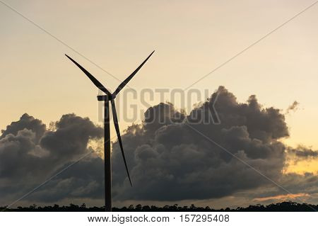 Silhouette wind generators turbines on sunset summer landscape in Thailand