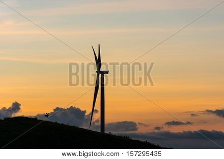 Silhouette wind generators turbines on sunset summer landscape in Thailand