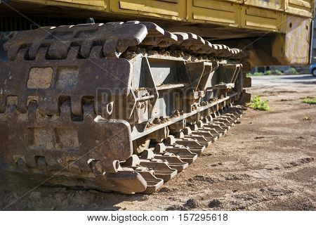 Closeup of the caterpillar track of a heavy construction machine.