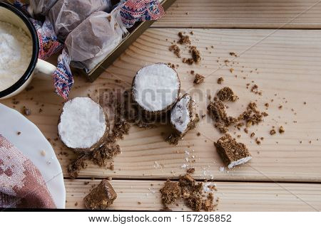 Top view of polvoron typical sweets consumed in Spain at Christmas. Spanish shortbread on wood background with plate and sugar.