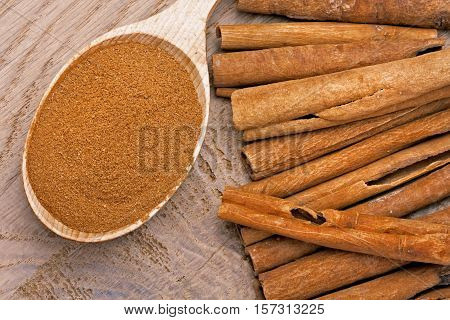 Cinnamon in sticks and powder studio shot wood background