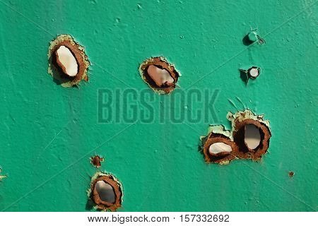 holes from shrapnel in the metal war