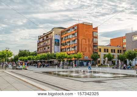PRISTINA, KOSOVO - JULY 01, 2015: People walking by the new fountain on Scanderbeg square in city center.