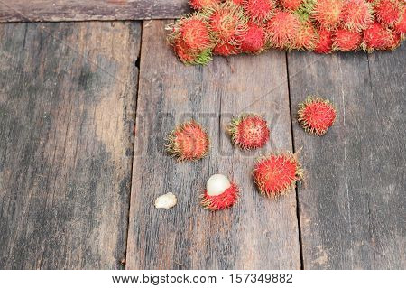 rambutan sweet fruit fresh on wood background :Select focus with shallow depth of field.