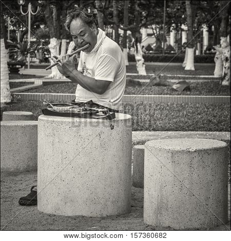 Flautist in Nha-Trang. Vietnam. May of 2016