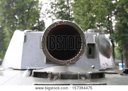 Aimed gun barrel. Detail of military weapons.