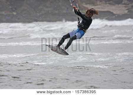 kitesurfer jumping in the sea off Bantham