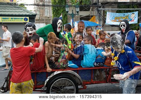 Bangkok, Thailand - April 13, 2008 : 
During Songkran the Thai New Year's festival. Teenagers watering passers-by on the street.
