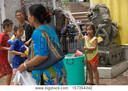 Bangkok, Thailand - April 13, 2008 : 
During Songkran the Thai New Year's festival. Teenagers watering passers-by on the street.