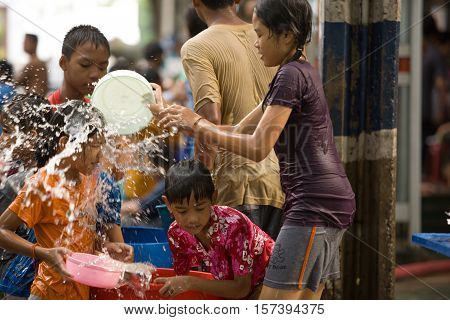 Bangkok, Thailand - April 13, 2008 : 
During Songkran the Thai New Year's festival. Teenagers watering passers-by on the street.