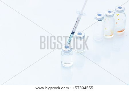 Vaccine in vial with syringe isolated on white background.