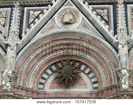 Siena - marble Duomo portal. The Duomo of Siena which was built in the 12th and 13th centuries is one of the prettiest churches in Gothic style in Italy